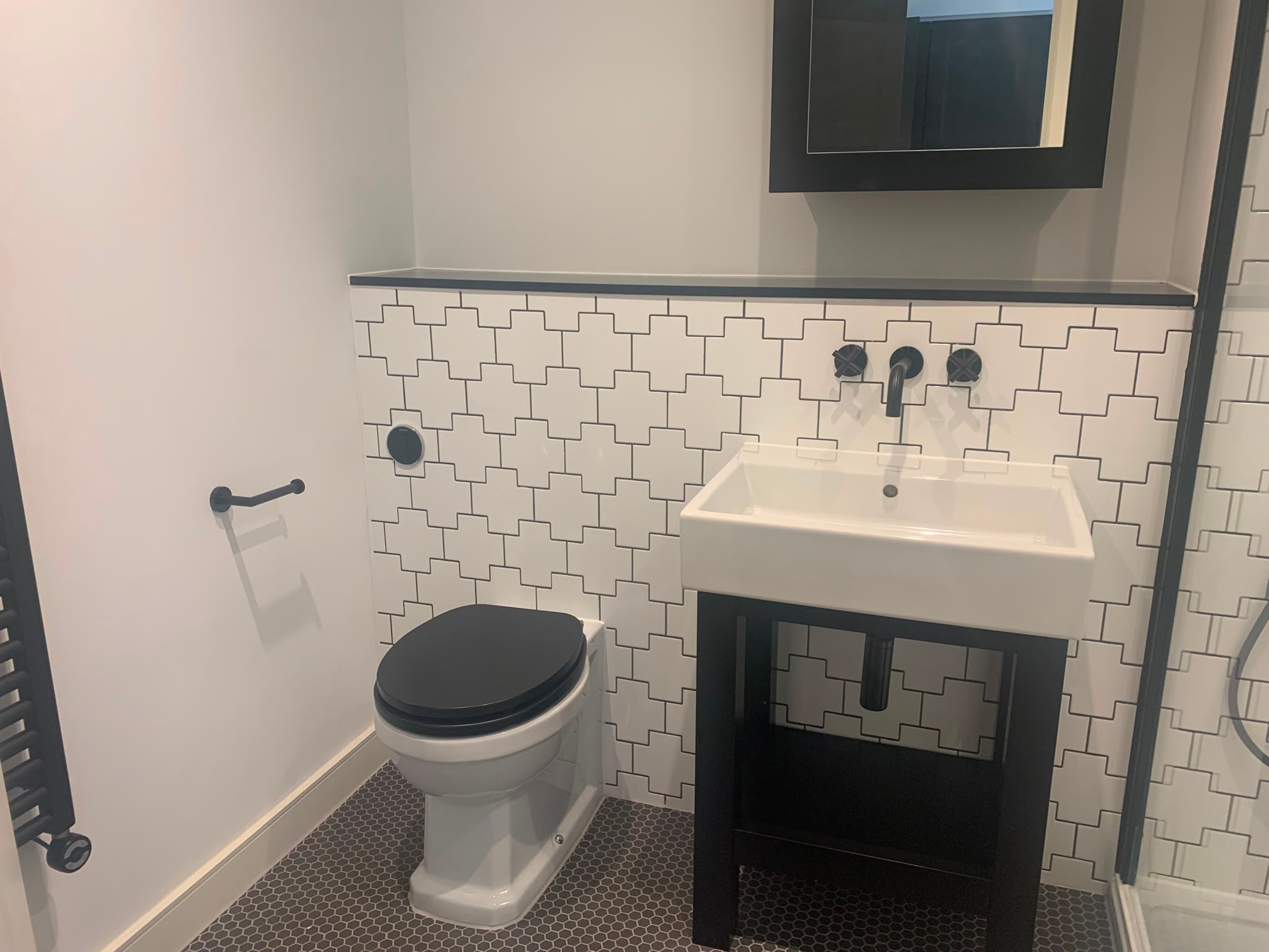 Modern bathroom with geometric tiles professionally cleaned to a high standard