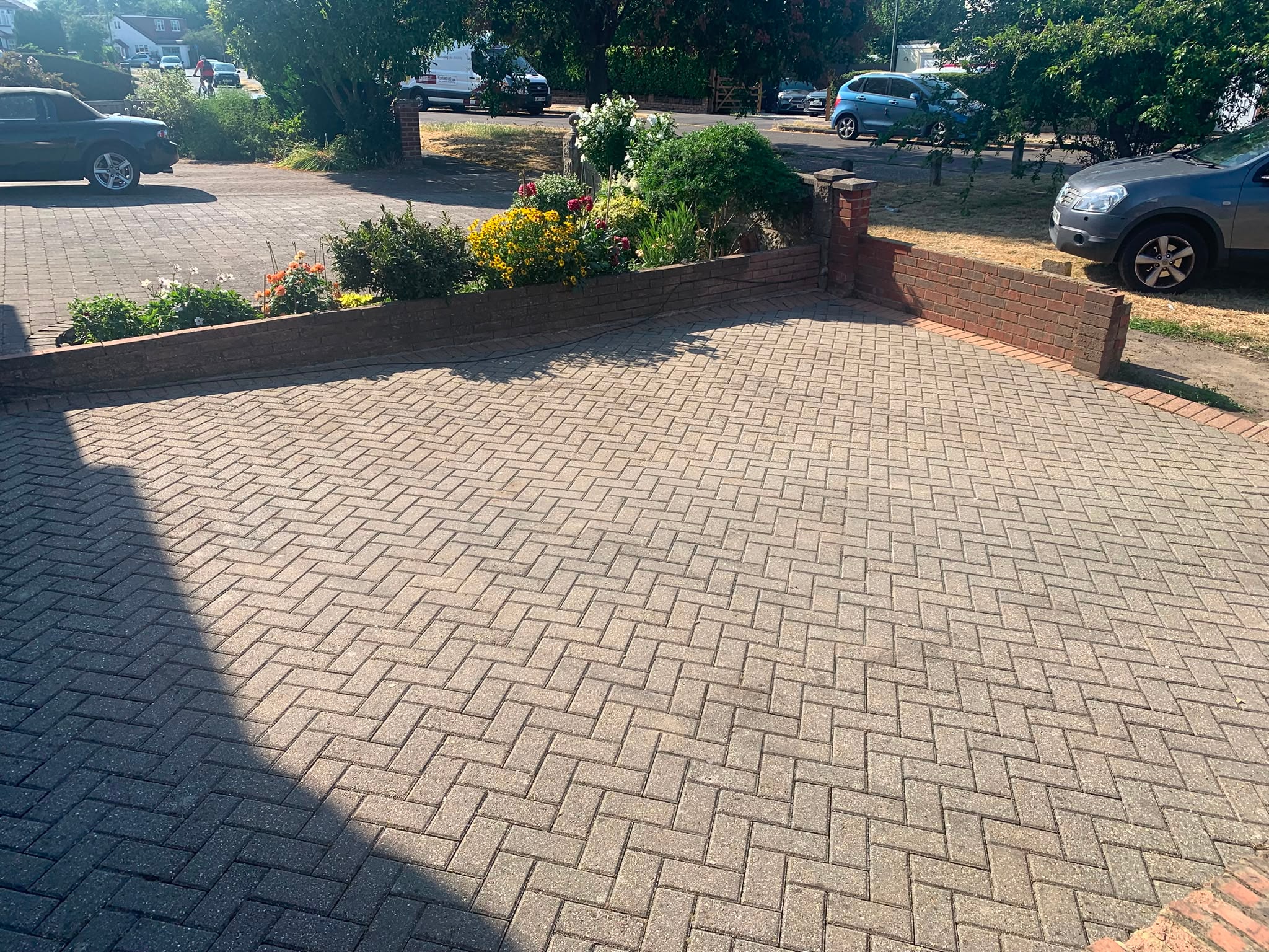 Block paving driveway after pressure washing — clean herringbone brickwork restored