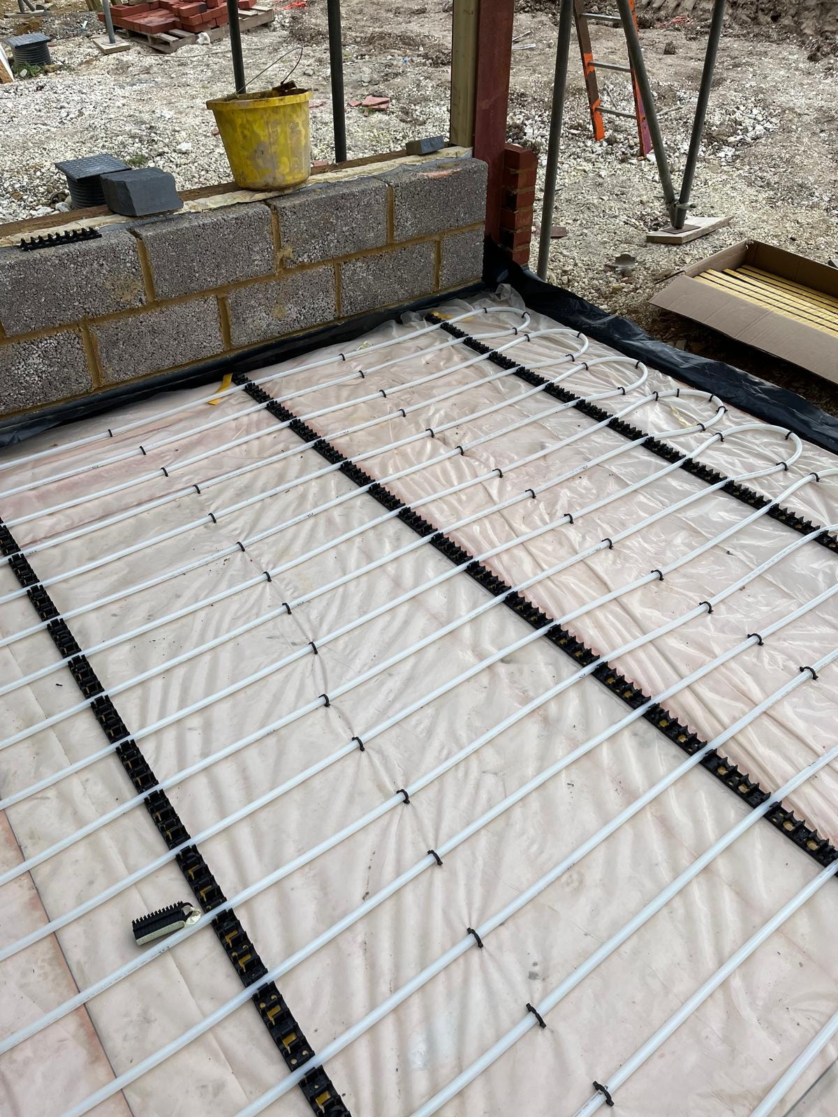 Underfloor heating pipe installation laid out on insulation board — Surrey