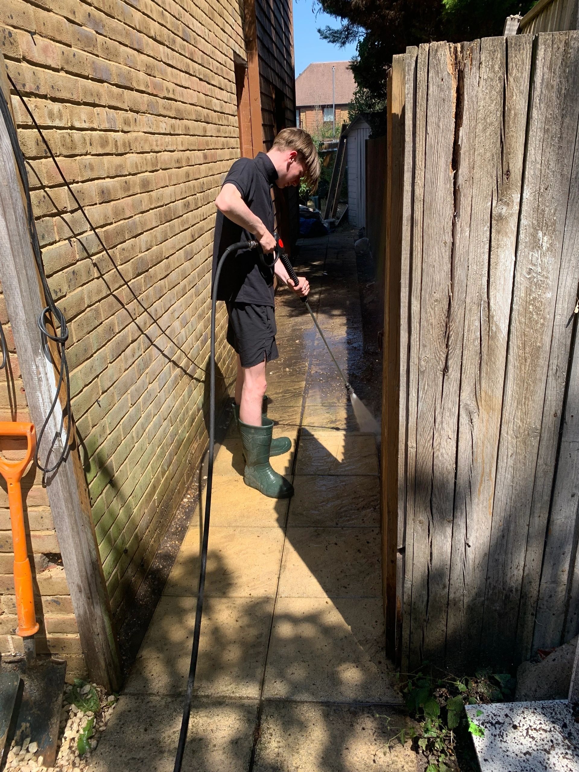 AM 2 PM team pressure washing a residential alleyway in Surrey